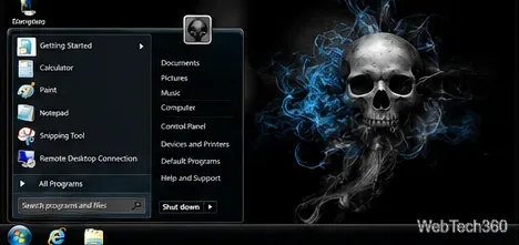 Un escritorio oscuro al estilo de Windows 7 con un fondo de pantalla de calavera y un menú de inicio negro.