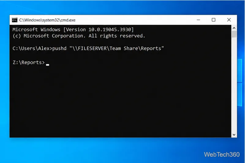 Command Prompt showing pushd with the example UNC path and the resulting Z colon backslash Reports prompt