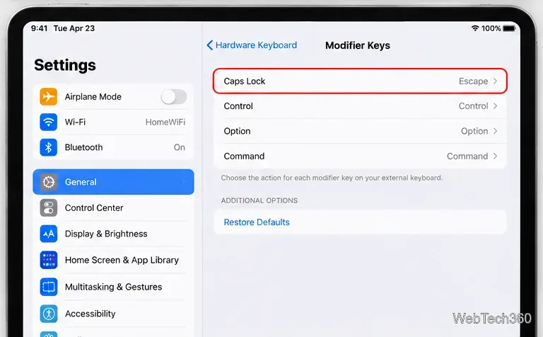 iPad Modifier Keys settings showing Caps Lock assigned to Escape and a Restore Defaults option
