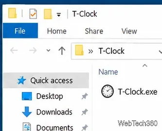 O Explorador de Arquivos está aberto em uma pasta T-Clock extraída, com o arquivo T-Clock.exe visível.