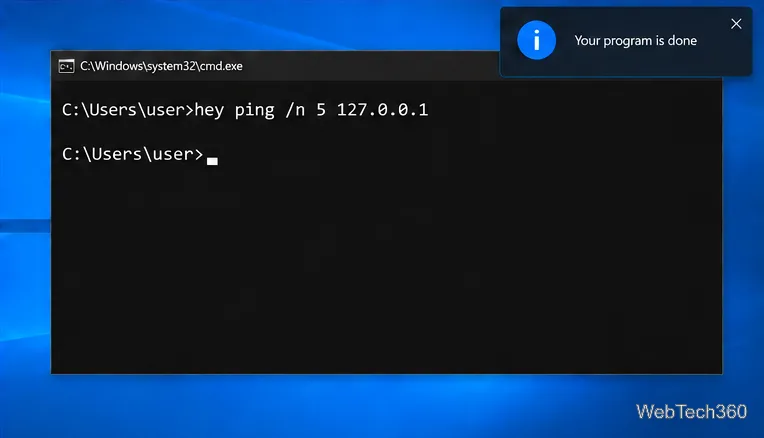 Un comando ping incapsulato in Hey completato con una notifica di Windows che dice "Il tuo programma è terminato"