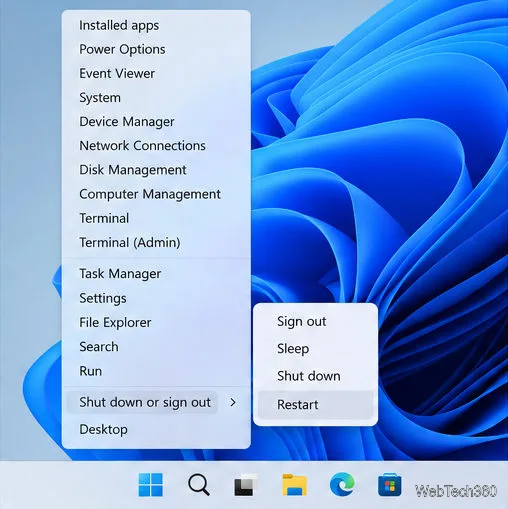 O menu de Atalhos Rápidos do Windows 11 mostra a opção Desligar ou encerrar sessão expandida, com a opção Reiniciar no submenu.