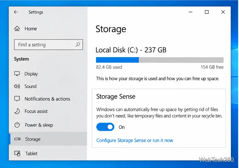 Windows 10 Settings on System and Storage, showing Storage Sense turned on and its configuration link.