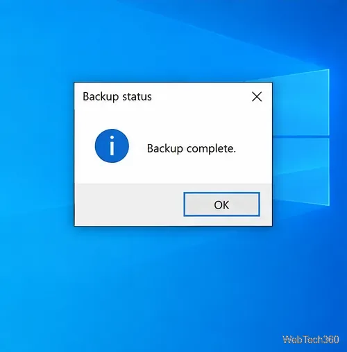 A Windows information message box titled Backup status with an OK button on the desktop.