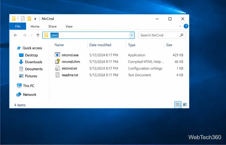 Exploratorul de fișiere Windows 10 cu folderul NirCmd extras deschis și comanda cmd tastată în bara de adrese