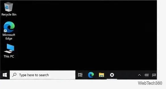 Рабочий стол Windows 10 с простым черным фоном, значками рабочего стола и панелью задач.