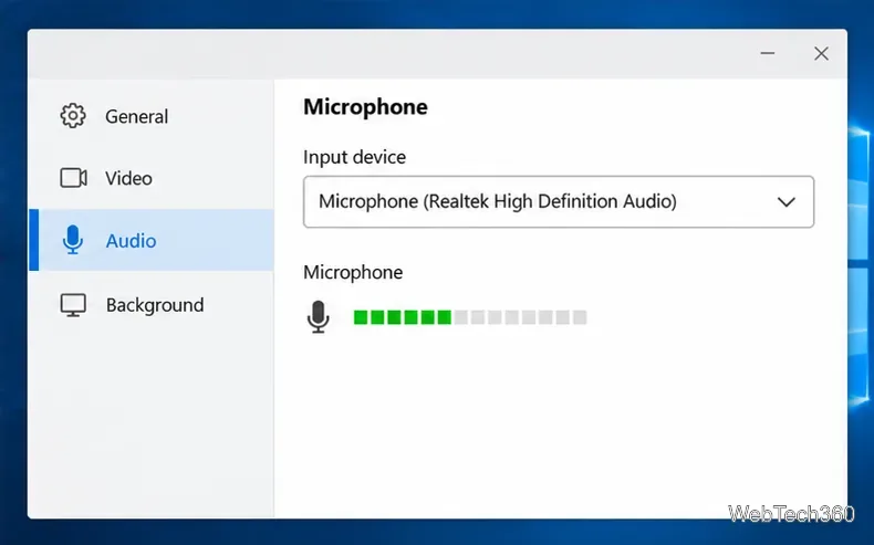A desktop app audio settings page with a microphone selected as the input device and an active level meter.