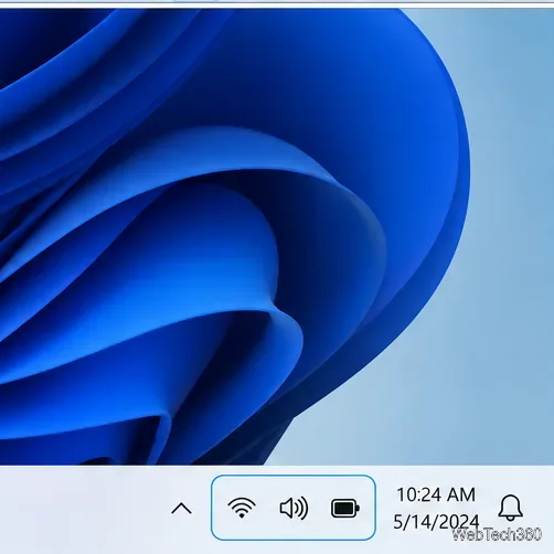 Barre des tâches de Windows 11 avec les icônes réseau, son et batterie regroupées près de l'horloge