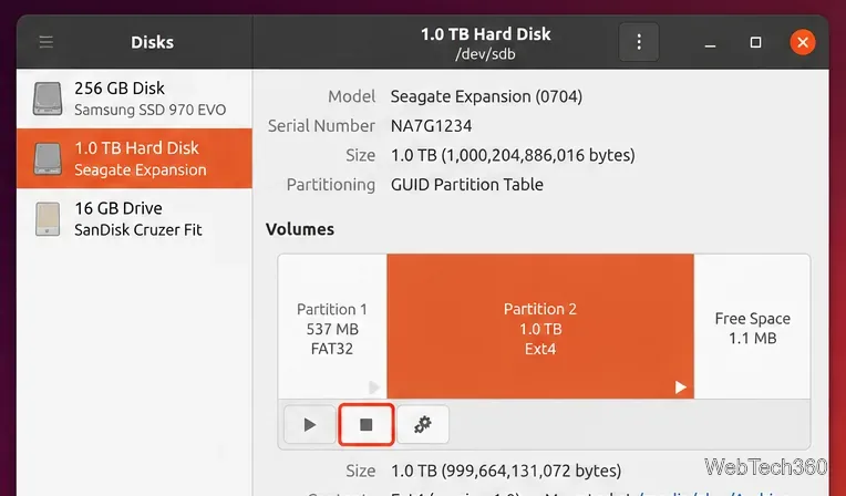 Ubuntu Disks window showing a 1 TB hard drive, its partitions, and the square stop button used to unmount a volume
